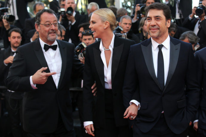 Actors Jean Reno, from lHt, ChaHize Theron and Javier Bardem pose for photographers upon arrival at the screening of the film The Last Face at the 69th international film festival, Cannes, southern France, Friday, May 20, 2016.