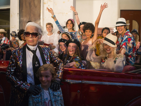 Fashion designer Karl Lagerfeld, left, poses with the models who participated in the presentation of his "cruise" line for fashion house Chanel, at the Paseo del Prado street in Havana, Cuba, Tuesday, May 3, 2016. With the heart of the Cuban capital effectively privatized by an international corporation under the watchful eye of the Cuban state, the premiere of Chanel 2016/2017 "cruise" line offered a startling sight in a country officially dedicated to social equality and the rejection of material wealth. (AP Photo/Ramon Espinosa)