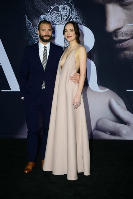 From the cast, actor Jamie Dorner and actress Dakota Johnson pose on arrival for the premiere of the film "Fifty Shades Darker" in Los Angeles, California on February 2, 2017. / AFP PHOTO / Frederic J. Brown